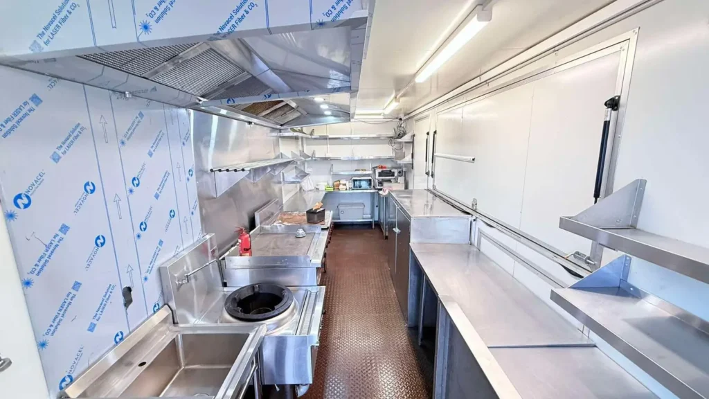 Commercial kitchen deep cleaning with sanitized equipment, benches, and food preparation areas.