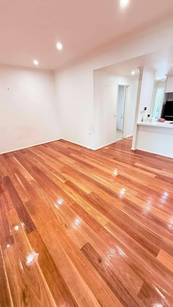 Professional timber floor cleaning and polishing completed in a residential living room.