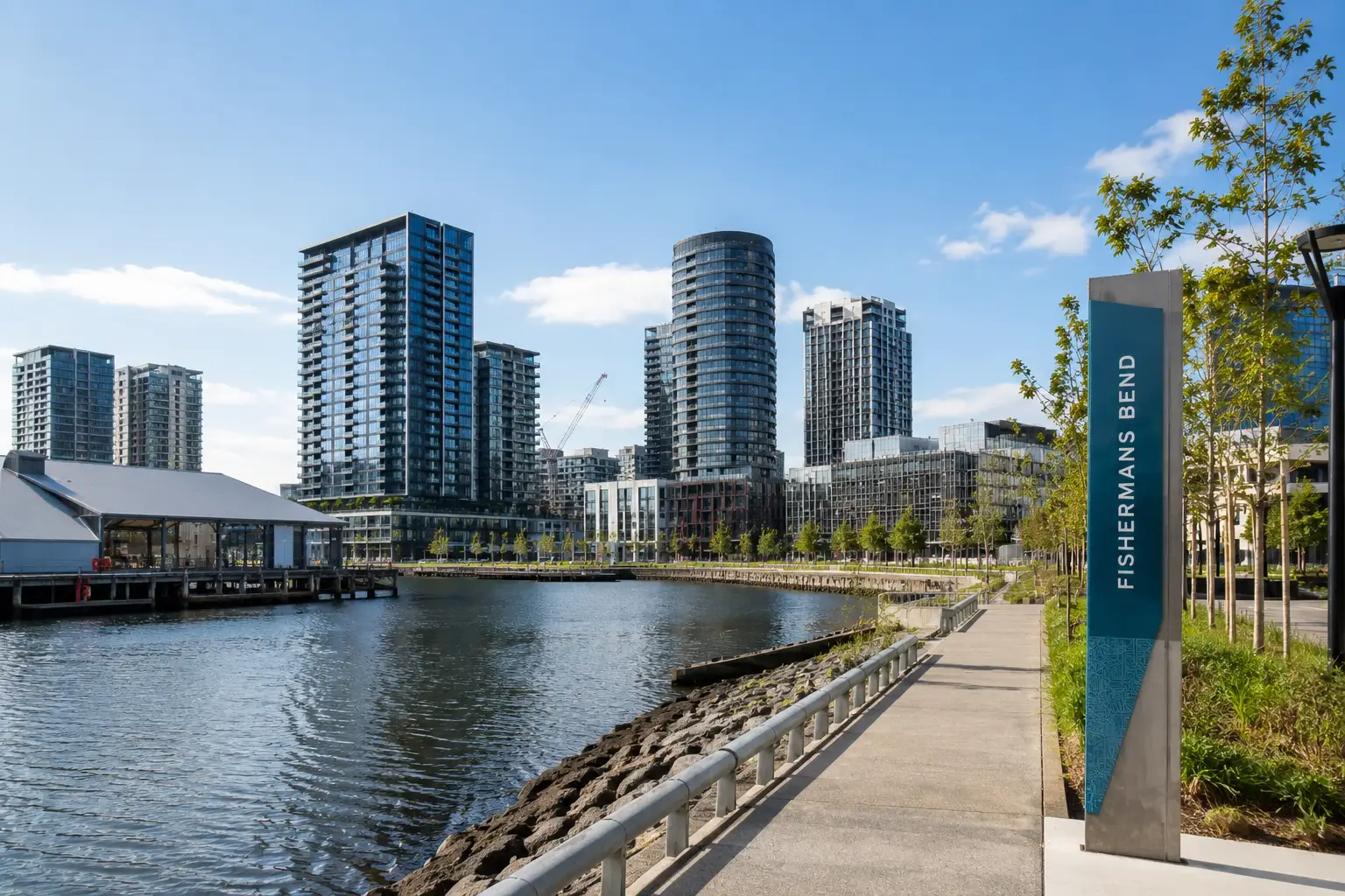 Modern Fishermans Bend precinct with contemporary apartments, waterfront promenade and commercial developments near Port Melbourne.